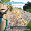 A close-up of a solid brass quick-connect garden hose fitting being used to connect water devices to a brick wall.