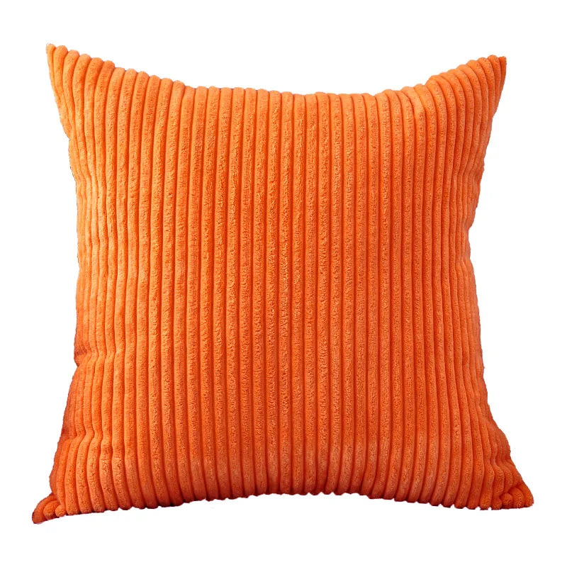 An orange ribbed corduroy cushion cover.