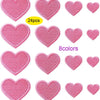 A collection of 24 pink heart-shaped iron-on patches in various shades and textures.
