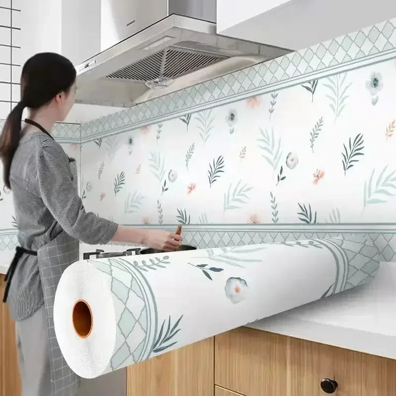 Roll of self-adhesive kitchen splashback sticker wallpaper featuring green leaves and floral designs