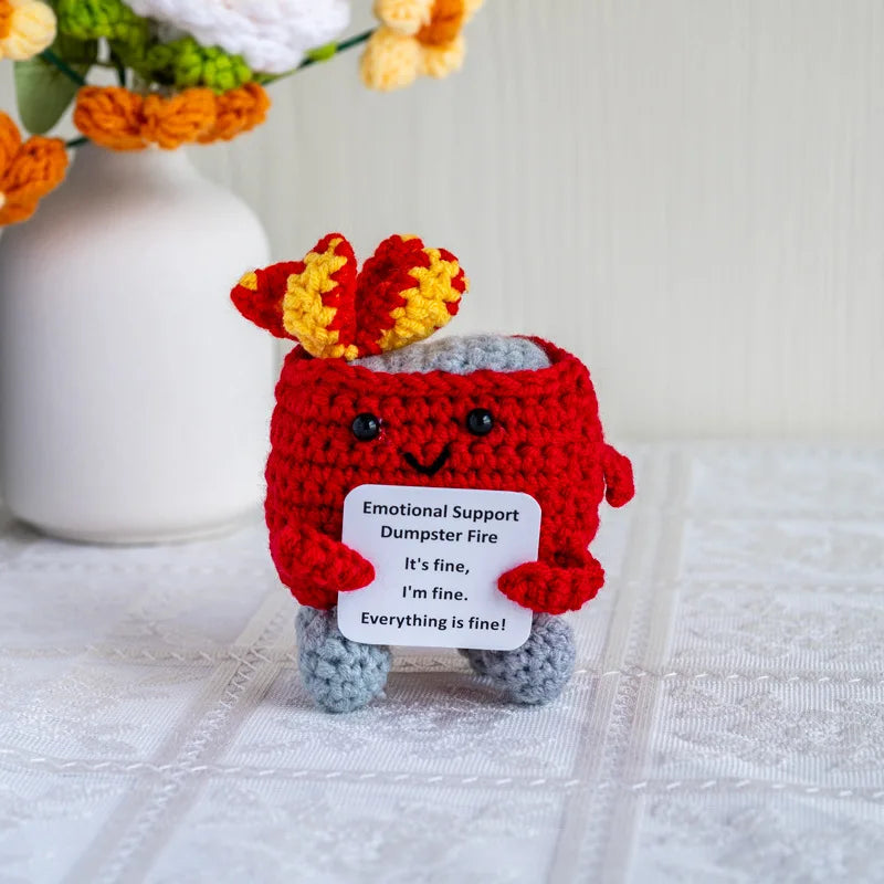 Handmade crochet dumpster fire doll with red and yellow hair and gray body for emotional support decor