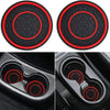 Two black silicone coasters with a hexagonal pattern and red trim shown alongside their use in a car cup holder.