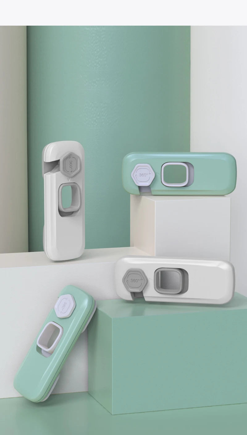 A set of child safety cabinet locks in mint green and white are displayed on a light green background.