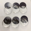 A collection of clear glass domes and dark gray magnets arranged in a row.