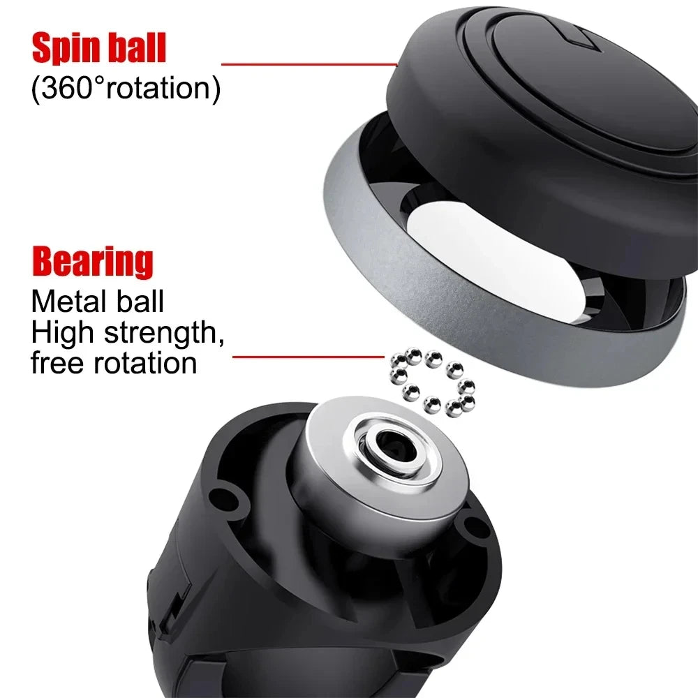 Close-up view of a black rotating steering wheel spinner knob showing the spin ball and bearing mechanism.