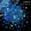 A close-up of iridescent blue and purple holographic star sequins scattered on a dark background.