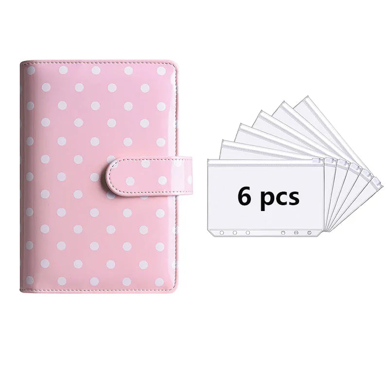 Pink polka dot PU leather binder wallet with cash envelopes and card holder shown next to a stack of six plastic cards