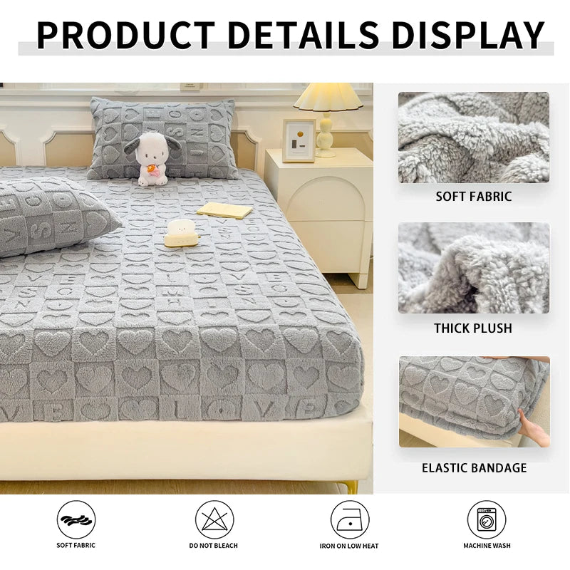 A gray plush mattress cover displayed on a bed, showing details like soft fabric and elastic bandage.
