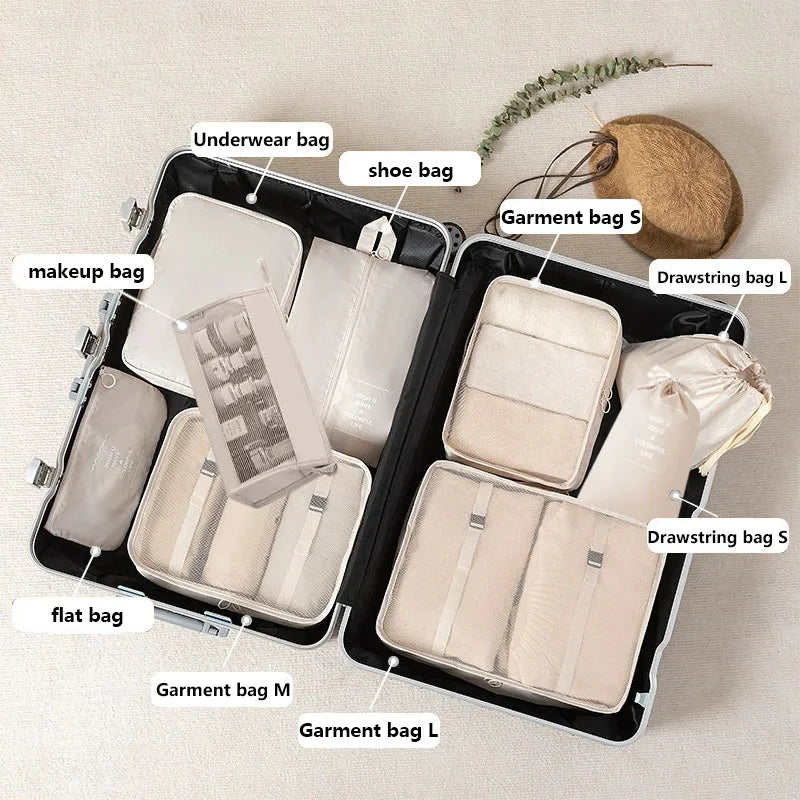 A set of black travel packing cubes and storage bags for organizing makeup, toiletries, and garments.