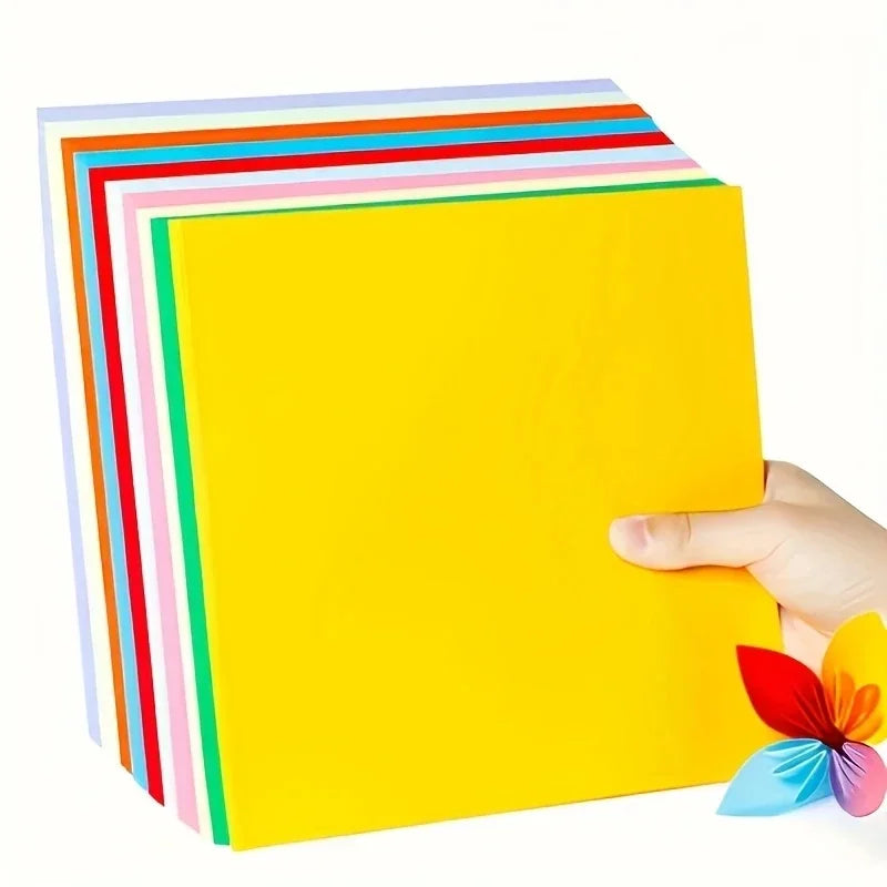 A stack of ten colored origami cardstock sheets, including yellow, pink, green, blue, red, and orange.