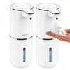 A white touchless automatic soap dispenser with a pump mechanism is shown next to a hand.