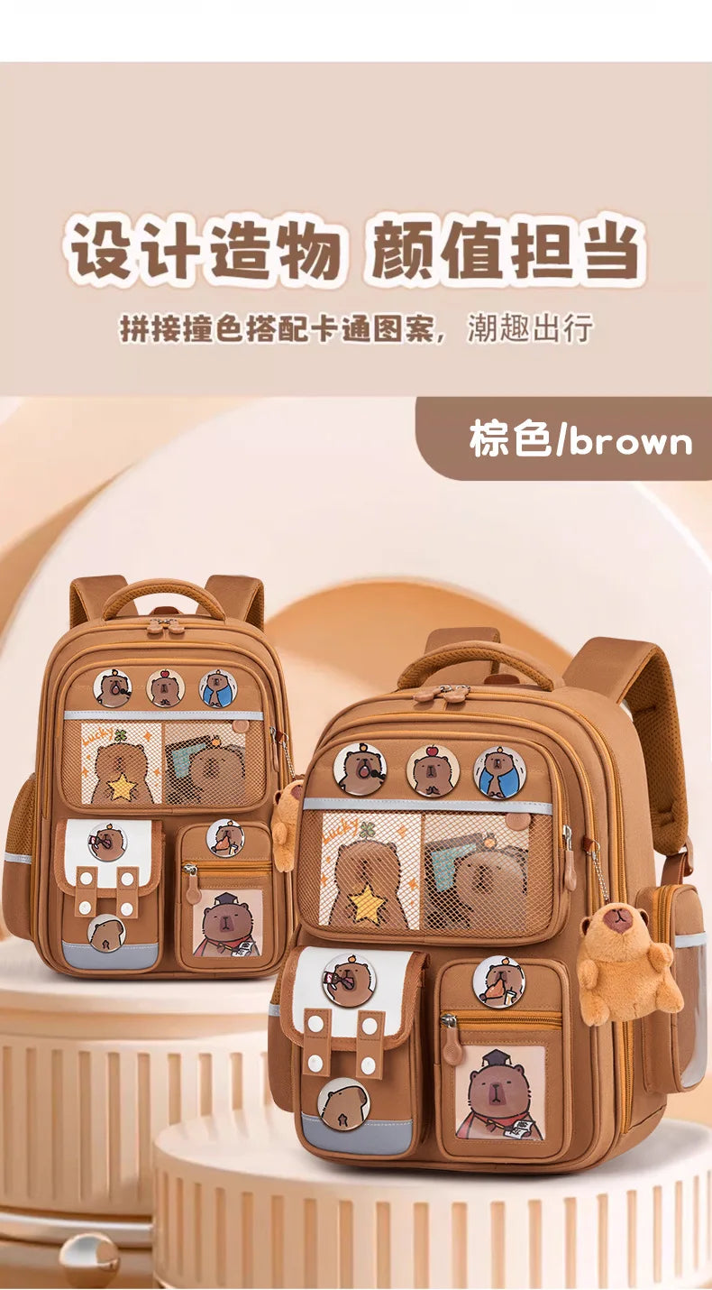 A brown kids school backpack featuring a capybara design with colorful embroidery and pockets.