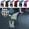 A close-up view of a universal car headrest hook with a sparkling, multi-colored design attached to a dark surface.