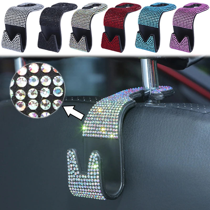 A close-up view of a universal car headrest hook with a sparkling, multi-colored design attached to a dark surface.