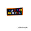 An embroidered letter patch with the text IN A CLASS ALL BY MYSELF in colorful block letters.