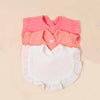 A set of three soft cotton ruffle bibs in pink and white for babies.