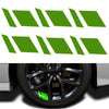 A set of six green reflective stickers designed for wheel hubs.