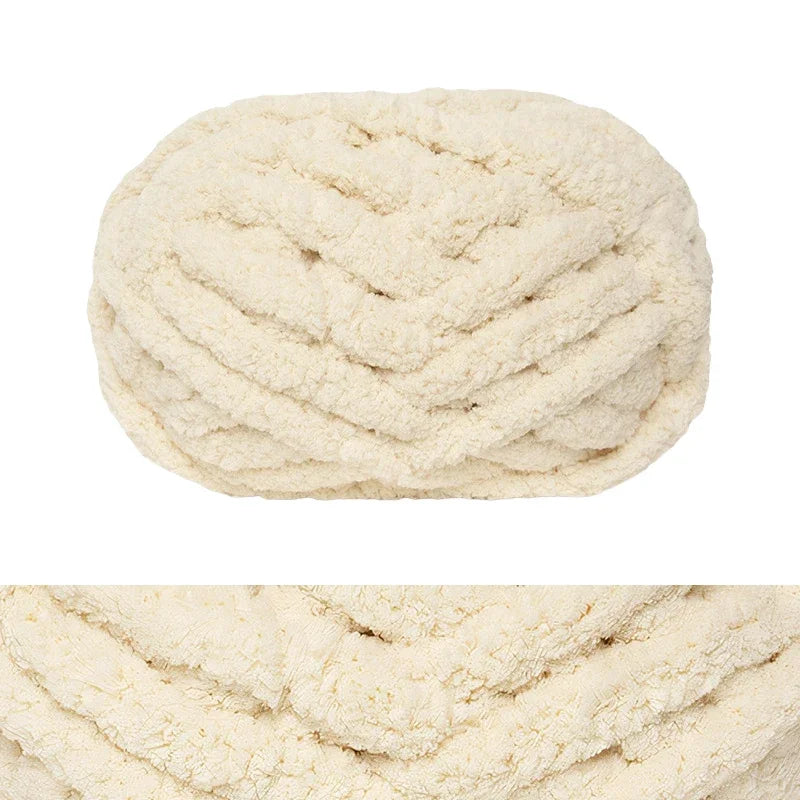 A ball of creamy white chunky chenille yarn for hand knitting and crochet