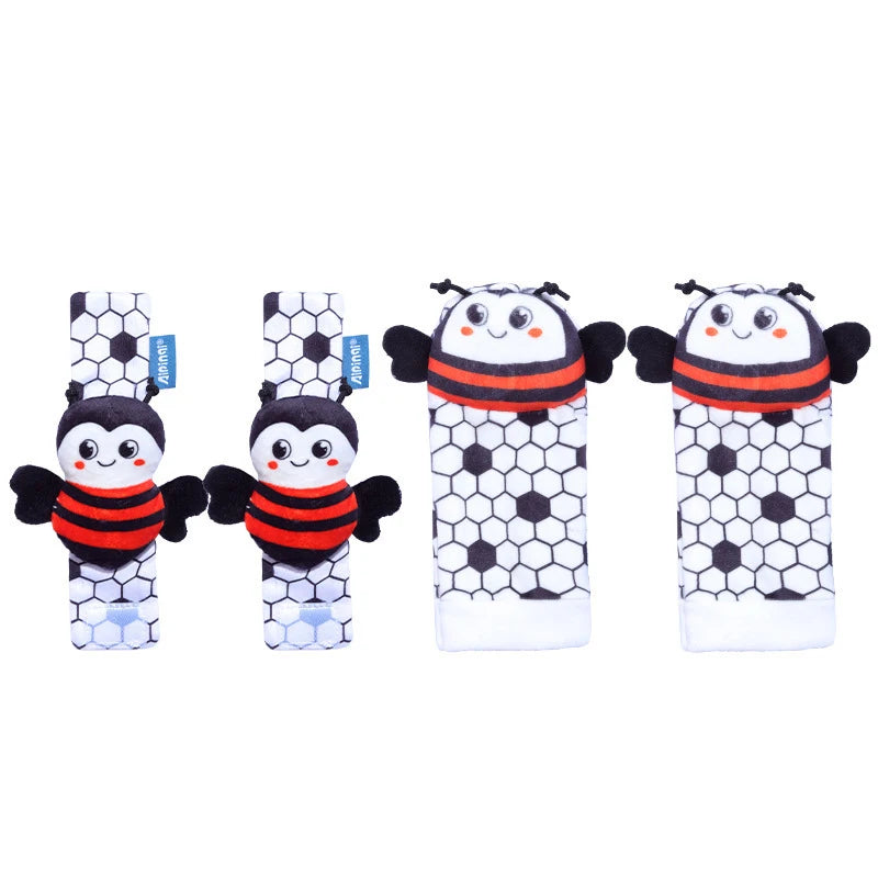 A set of black and white baby wrist and foot rattles featuring cute animal designs.