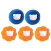 Three reusable laundry balls for pet hair and lint removal, featuring a white face design on blue and orange surfaces.