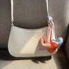 White heart-shaped PU leather bag with peach and blue fabric charms