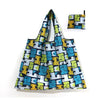 A reusable shopping tote bag featuring a pattern of stylized blue, yellow, and black animals.