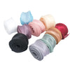 A collection of rolled organza ribbons in various pastel and deep shades including blue, pink, peach, and red.
