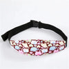 Black adjustable baby car seat sleeping headrest with a patterned fabric and a black belt strap.