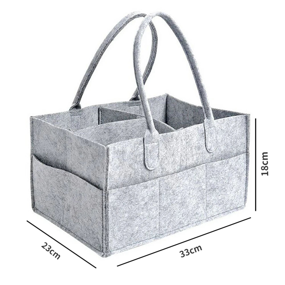 A light gray portable canvas diaper storage organizer with handles shown from above.
