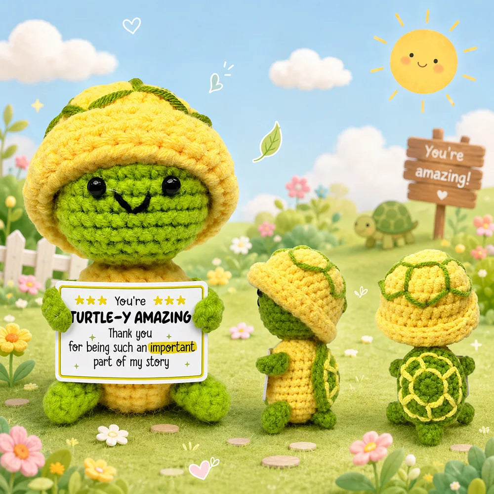 Handmade crochet turtle-shaped plush doll in yellow and green yarn sitting on a grassy background.