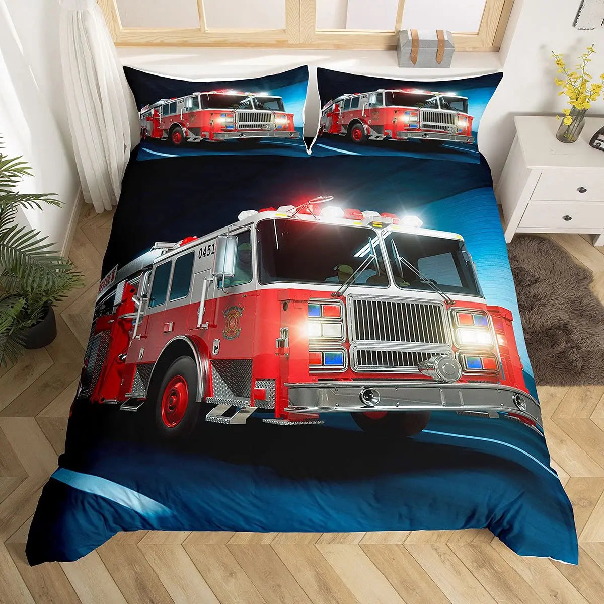 A bedding set featuring a graphic of red fire engines and firefighting vehicles on a dark blue background.