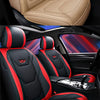 Close-up view of a black and red leather car seat with custom stitching and air bag compatibility features.