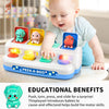 A baby is interacting with a pink and green push-and-pull dinosaur toy designed for sensory learning and fine motor skills.
