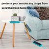 A silicone cover protects a remote control, featuring a cat ear design, resting on a white table.