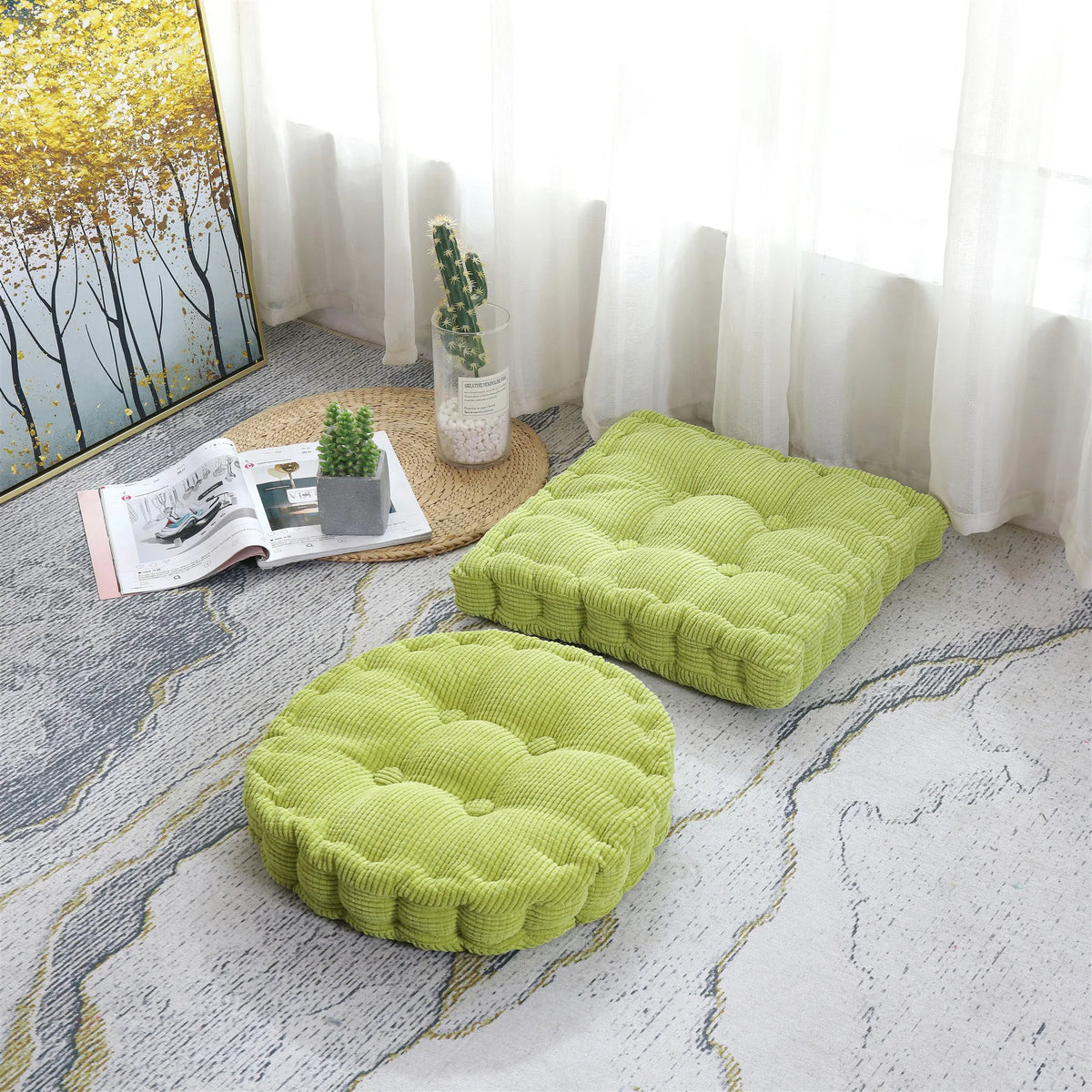 A bright lime green thick corduroy floor cushion is placed on a light gray patterned rug next to a window.