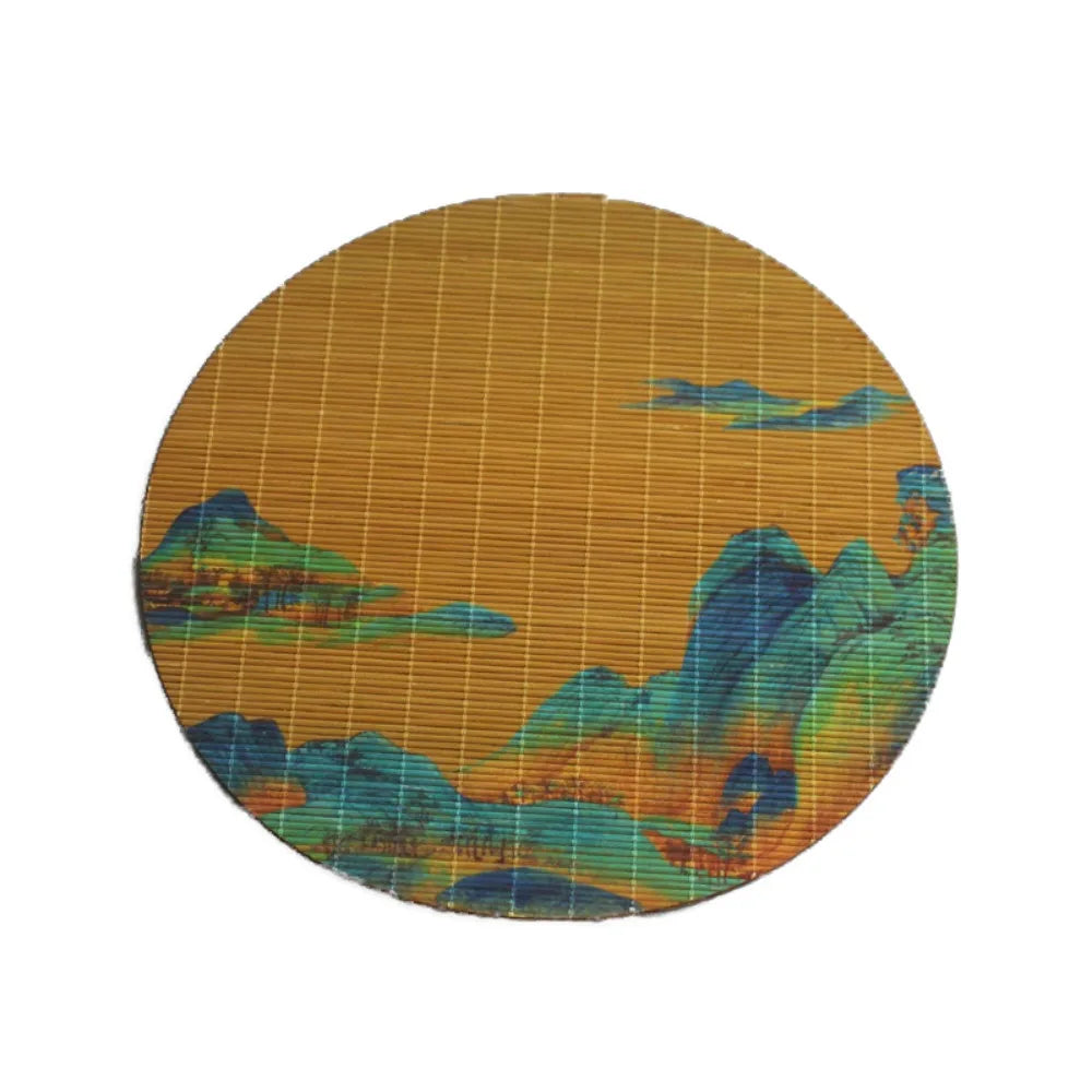 Round mat woven from bamboo showing abstract landscape colors and textures.