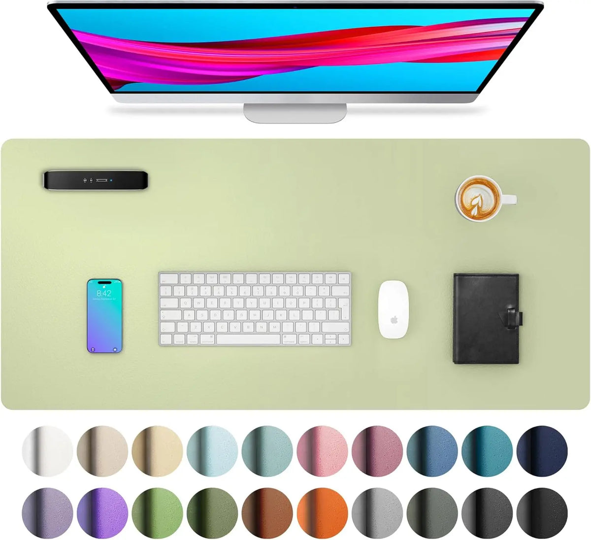 A computer monitor is shown above a desk pad featuring a keyboard, mouse, and a mug.