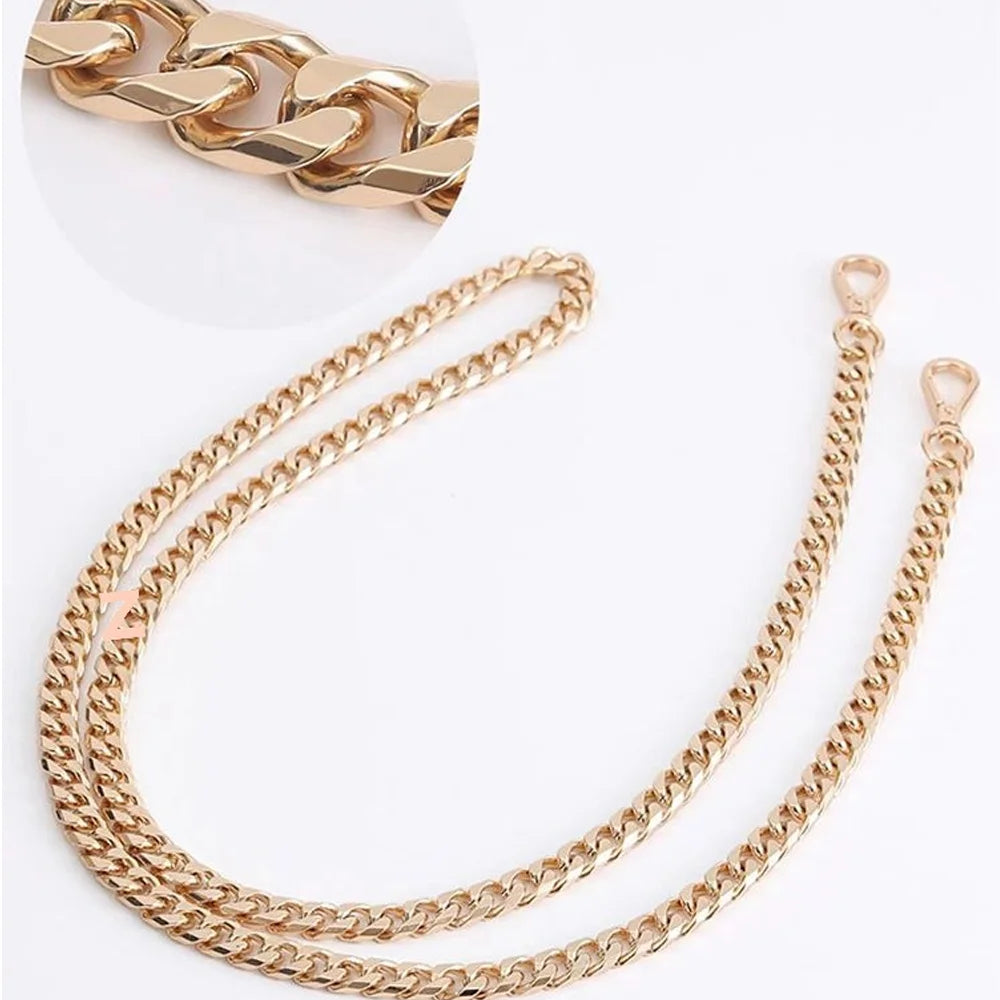 Gold-toned metal purse chain with interlocking links and a clasp shown next to a long, flexible chain.