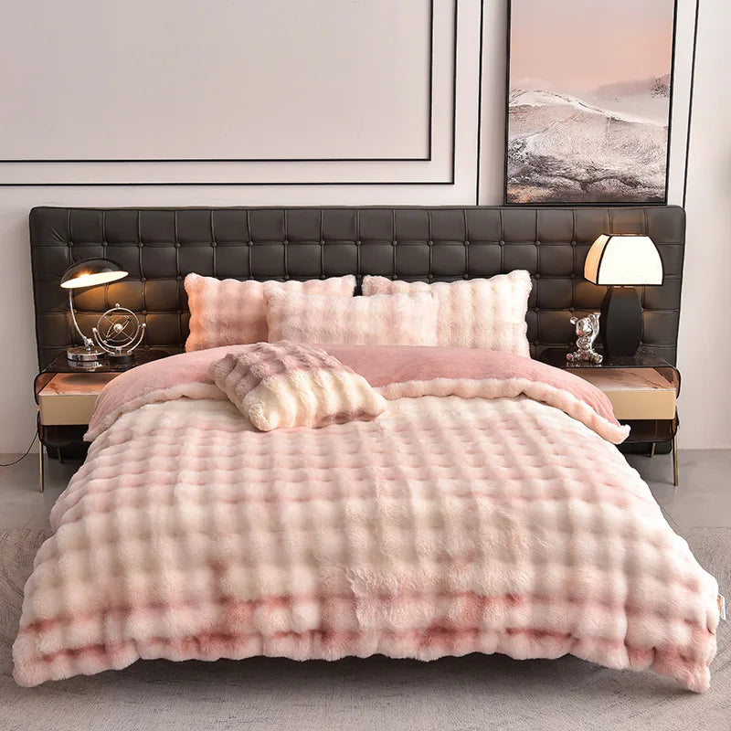 A pink faux fur duvet and pillow set displayed on a bed with a dark leather headboard.