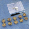 A silver instant no-sew snap button kit is shown on a white cloth, with several buttons laid out.