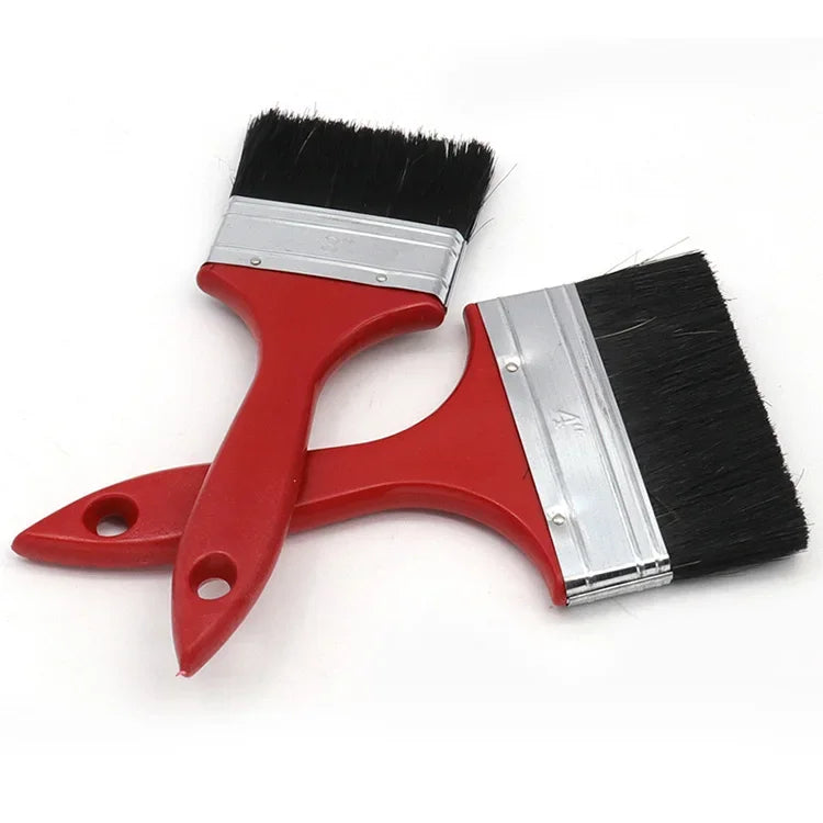 A red paint brush with a black bristles and silver metal ferrule on a plastic handle.