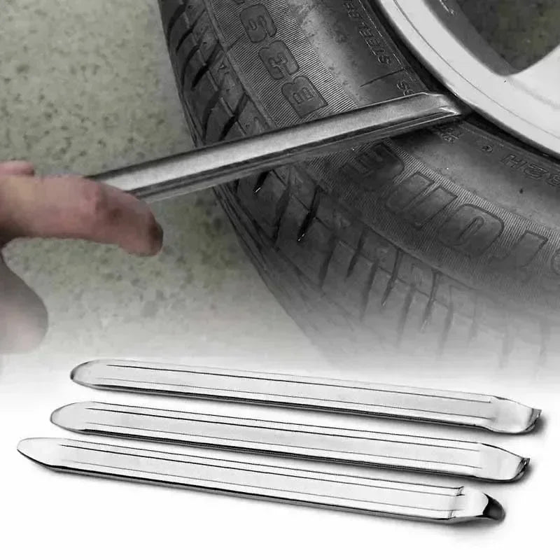 A close-up of a metal tire iron with a dual-end design resting on a tire.