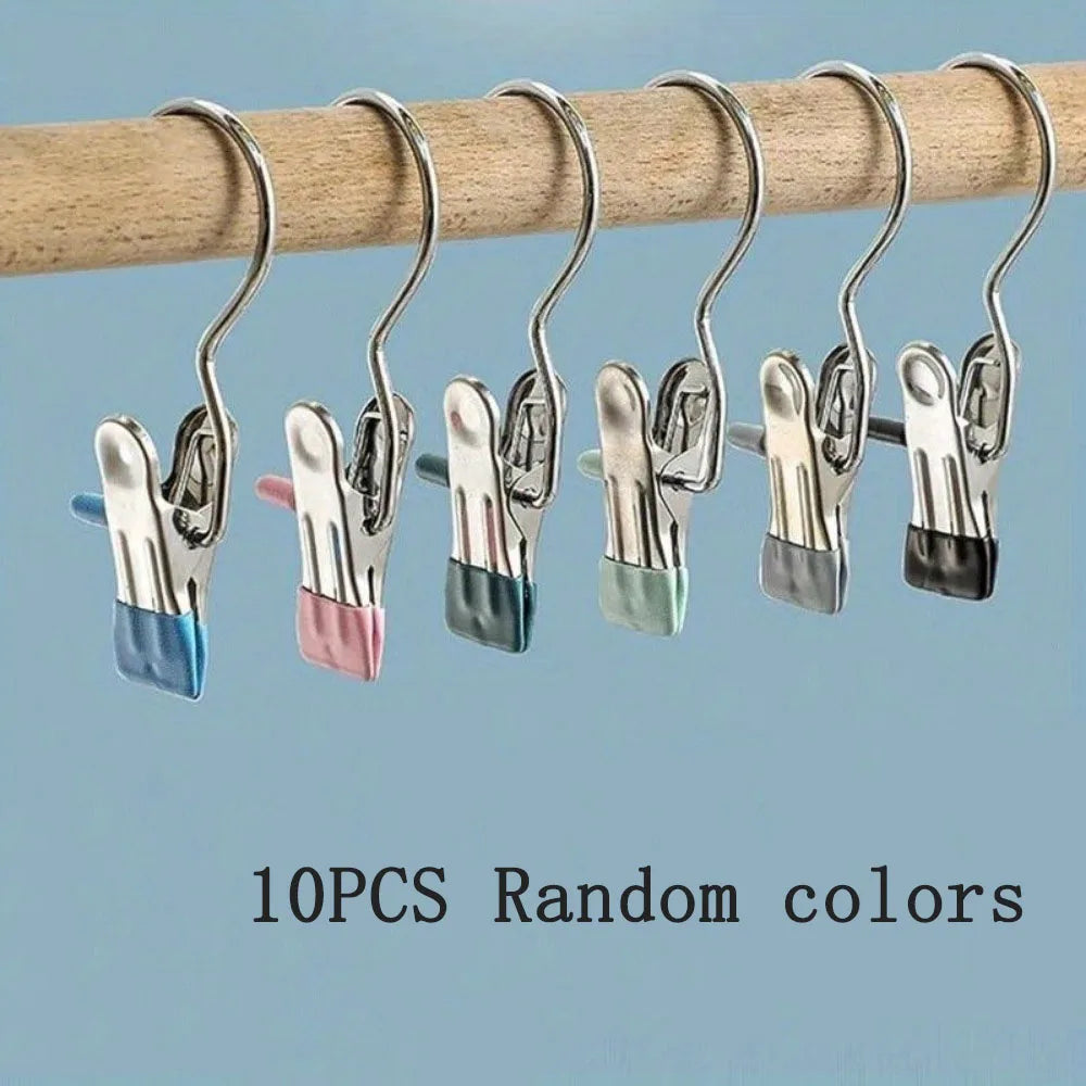 Ten heavy-duty metal hangers with various colored plastic grips hanging from a wooden rod