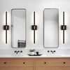 Modern bathroom vanity featuring a wooden cabinet, white countertop, and two rectangular mirrors with vertical LED sconces.