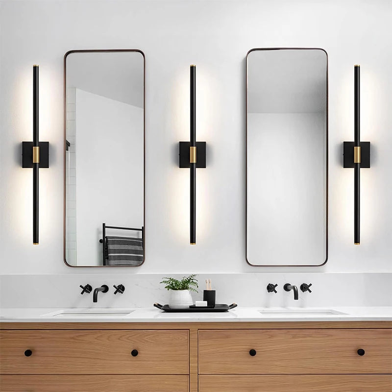 Modern bathroom vanity featuring a wooden cabinet, white countertop, and two rectangular mirrors with vertical LED sconces.