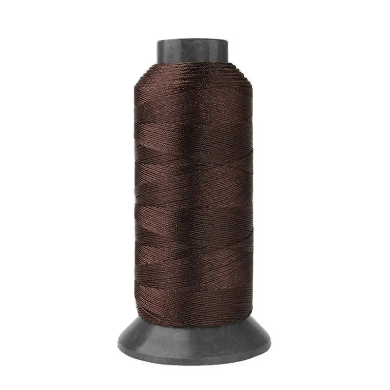 A spool of dark brown heavy-duty nylon sewing thread for upholstery and denim.