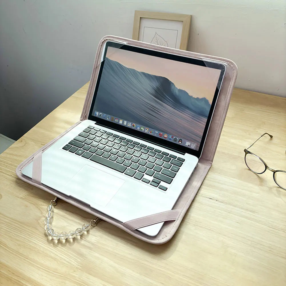 A pink water-resistant laptop briefcase is open, displaying a scenic wallpaper on a laptop screen.