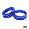 A pair of bright blue aluminum knob trim covers for a Ford Mustang, shown against a white background.