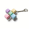 A keychain featuring five colorful, translucent mechanical keyboard fidget cubes attached to a silver keyring.