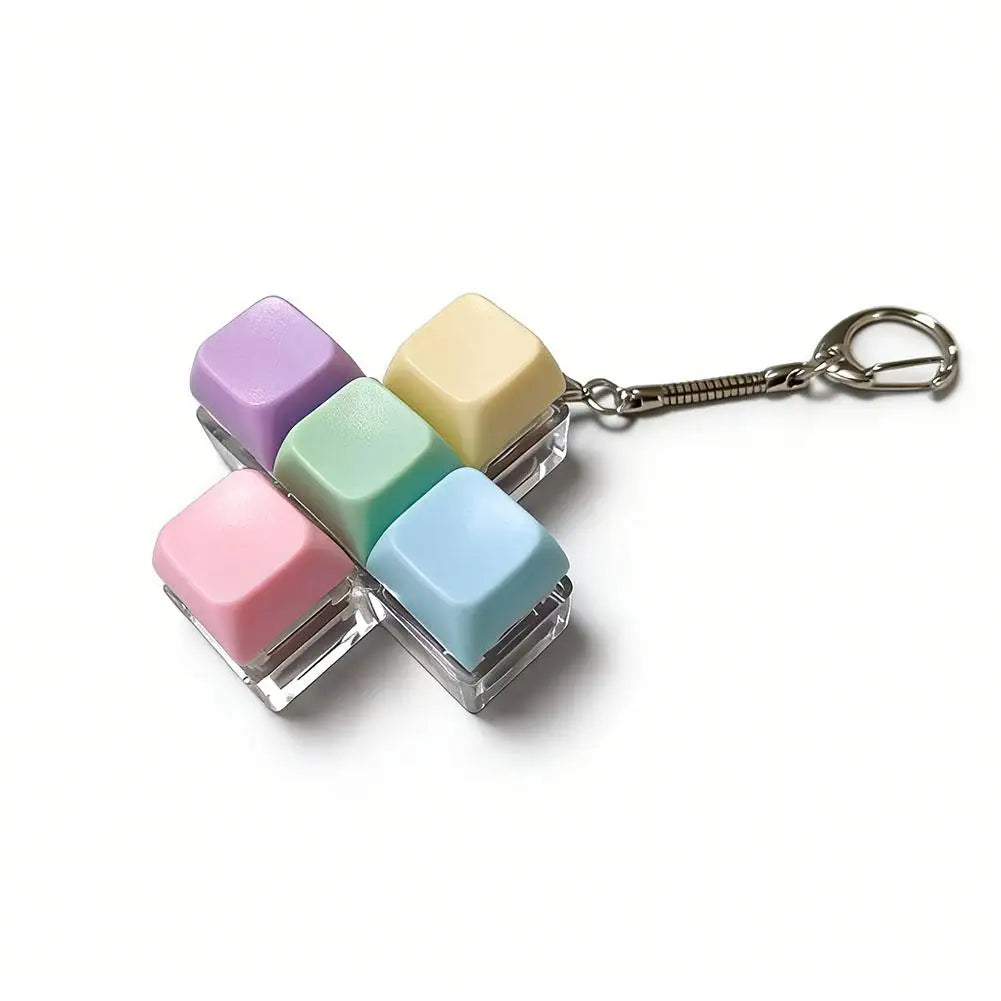 A keychain featuring five colorful, translucent mechanical keyboard fidget cubes attached to a silver keyring.